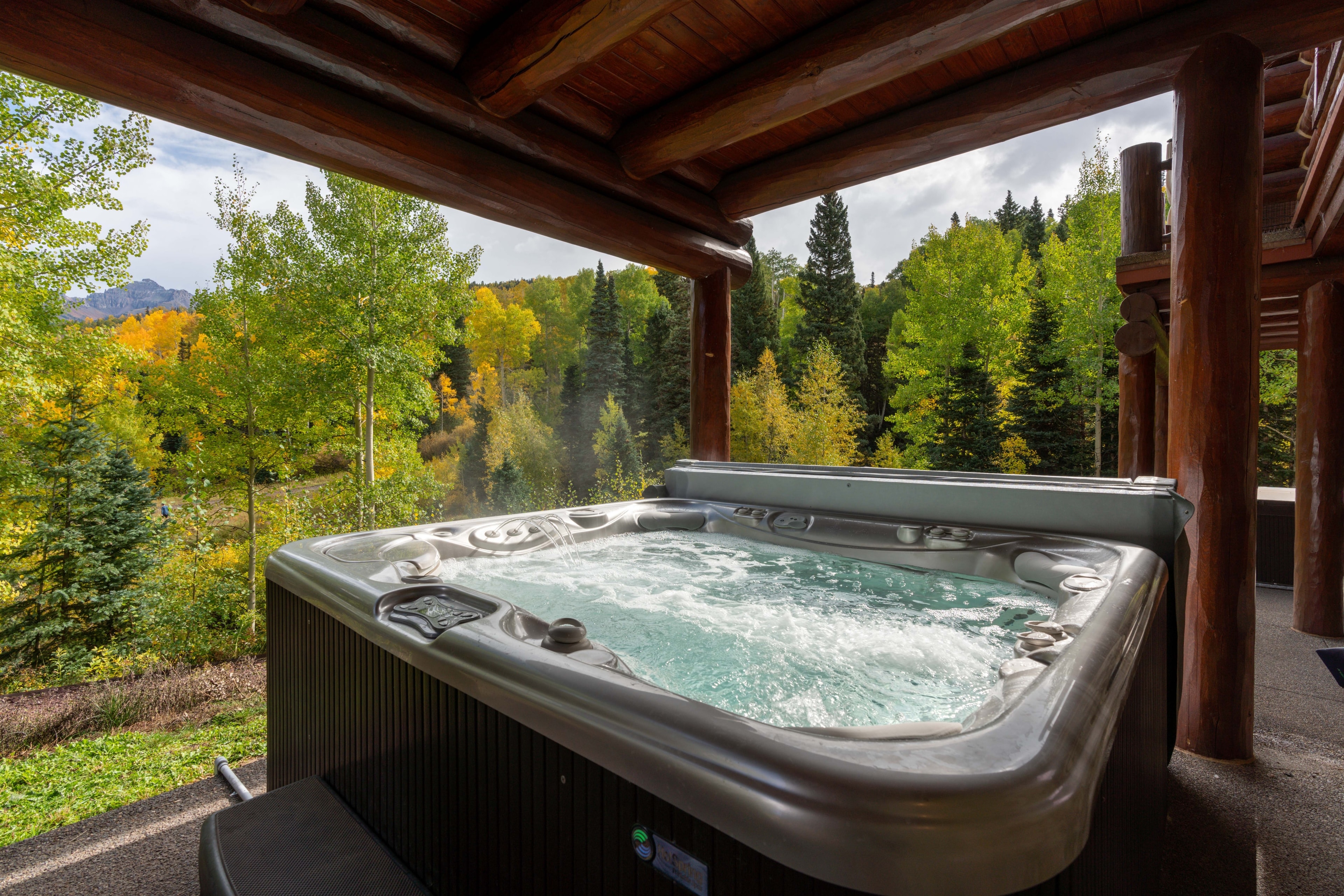 Covered hot tub looking toward the trees.