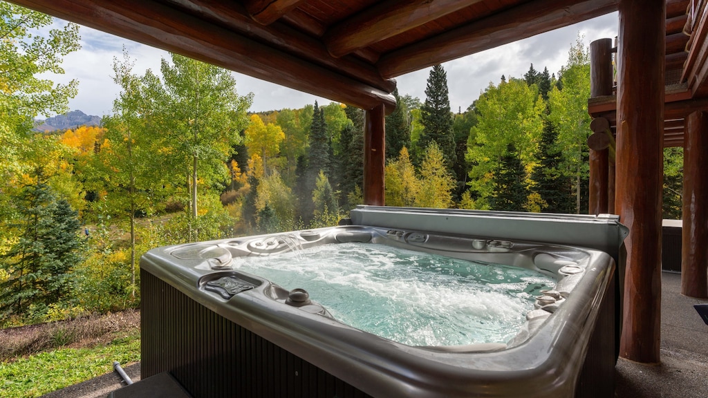 Covered hot tub looking toward the trees.