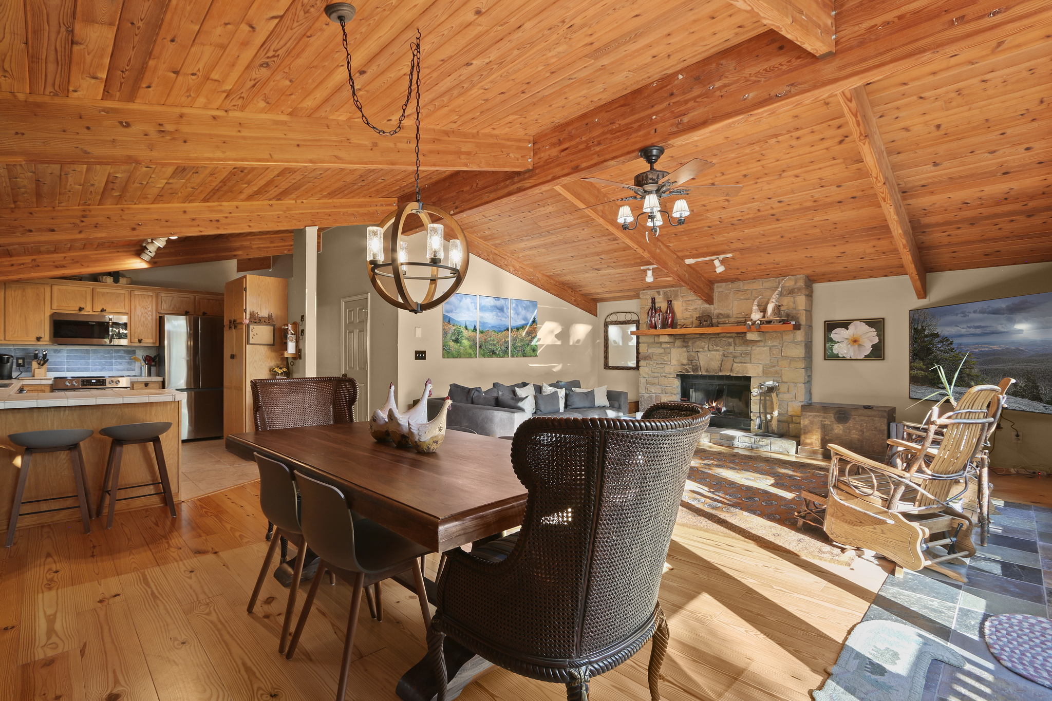 Adjacent to the living room, the cozy dining area invites you to enjoy a home-cooked meal at the rustic dining table.