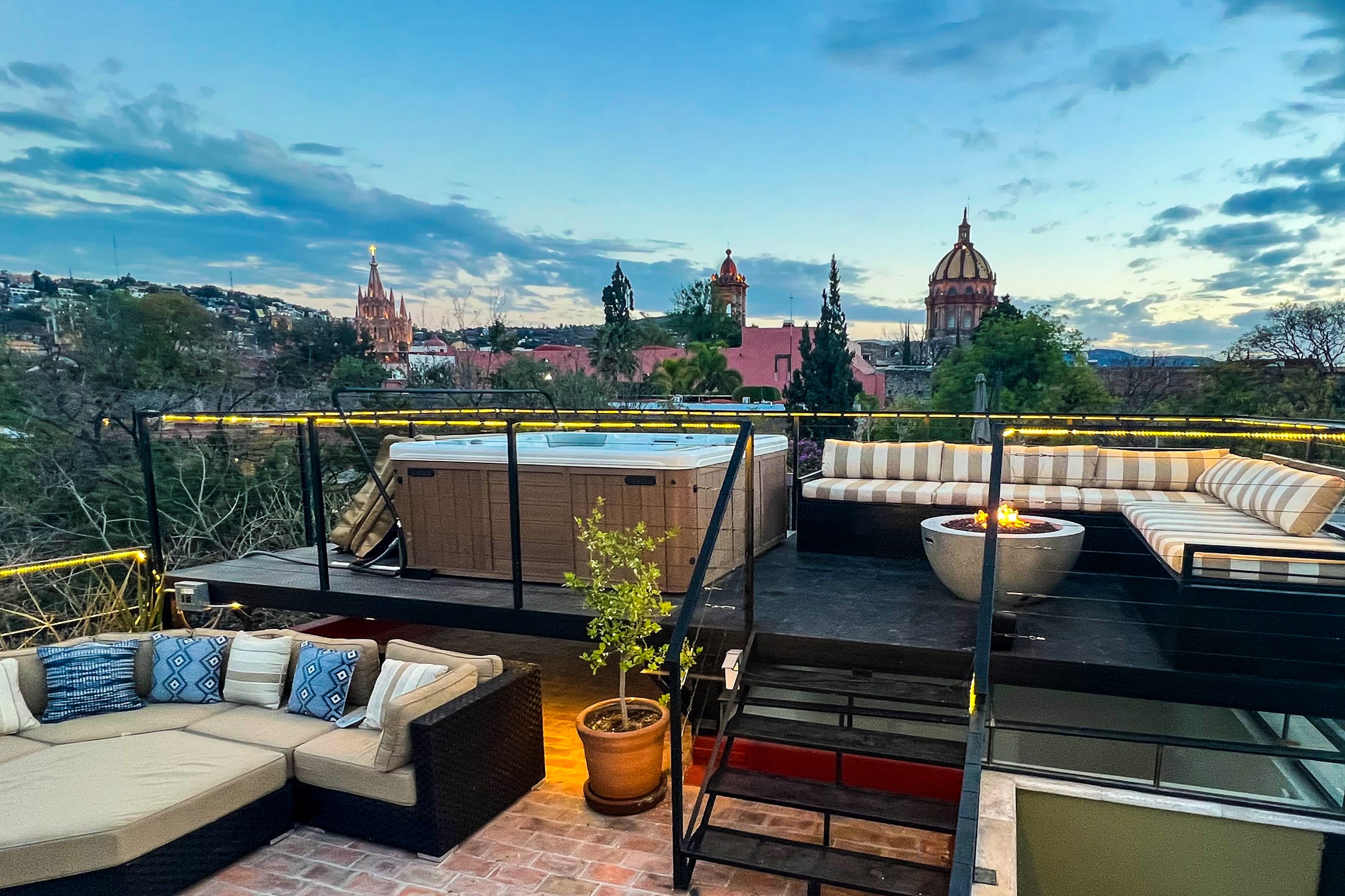 Private rooftop with hot tub jacuzzi, fire pit, lounge chairs and panoramic views of the Parroquia and other city landmarks.