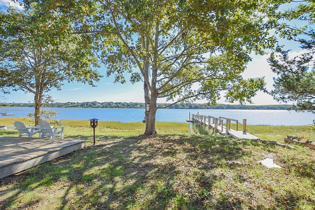 Cove view with dock and Adirondack chairs
