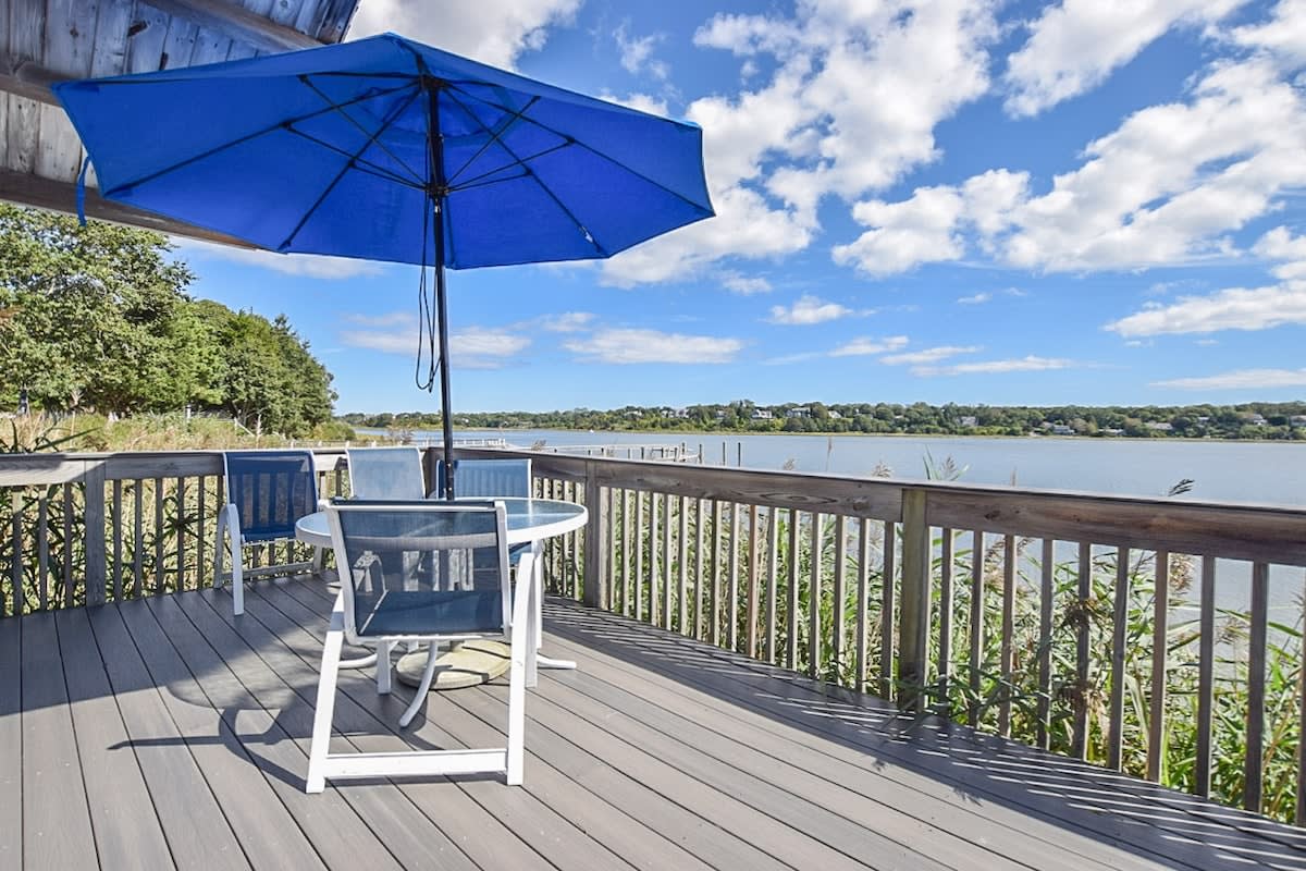 porch overlooking cove with table, chairs and umbrella