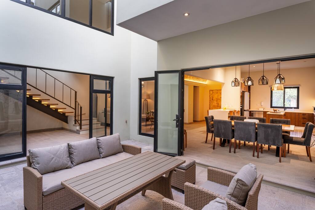 Indoor outdoor living area with formal dining room and an outdoor dining/sitting area.