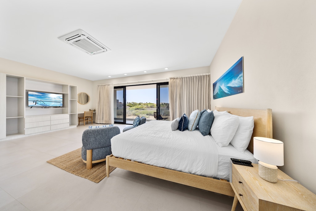 Indulge in a blissful retreat in deluxe bedroom of the apartment in Noord Aruba - Offering king size bed, smart TV and a private balcony for an unforgettable stay - This spacious bedroom comes with comfortable seating for added convenience