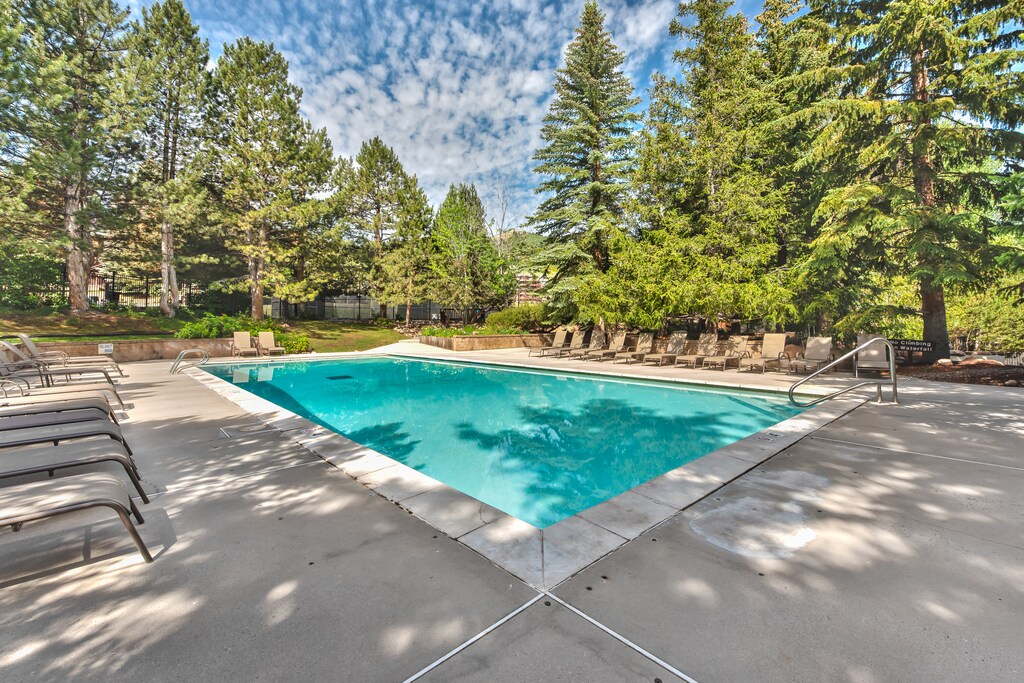 Clubhouse with a heated pool and hot tubs open in the winter and summer