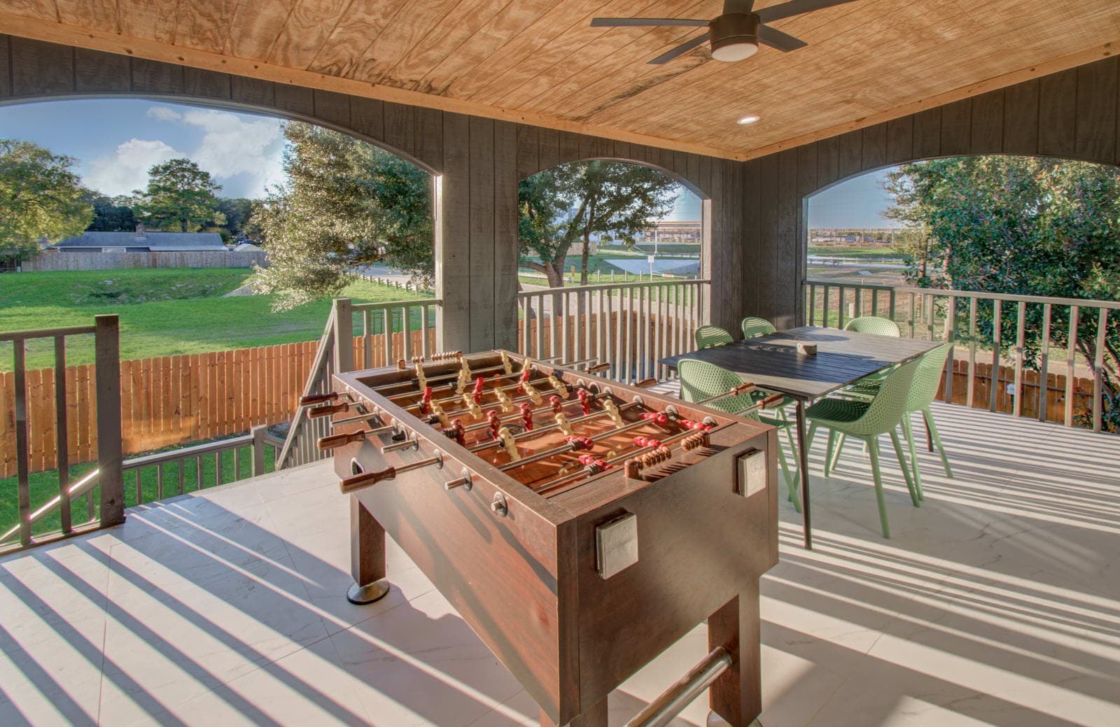 Challenge your friends to a friendly match of table tennis or foosball from the comforts of this oversized covered patio.