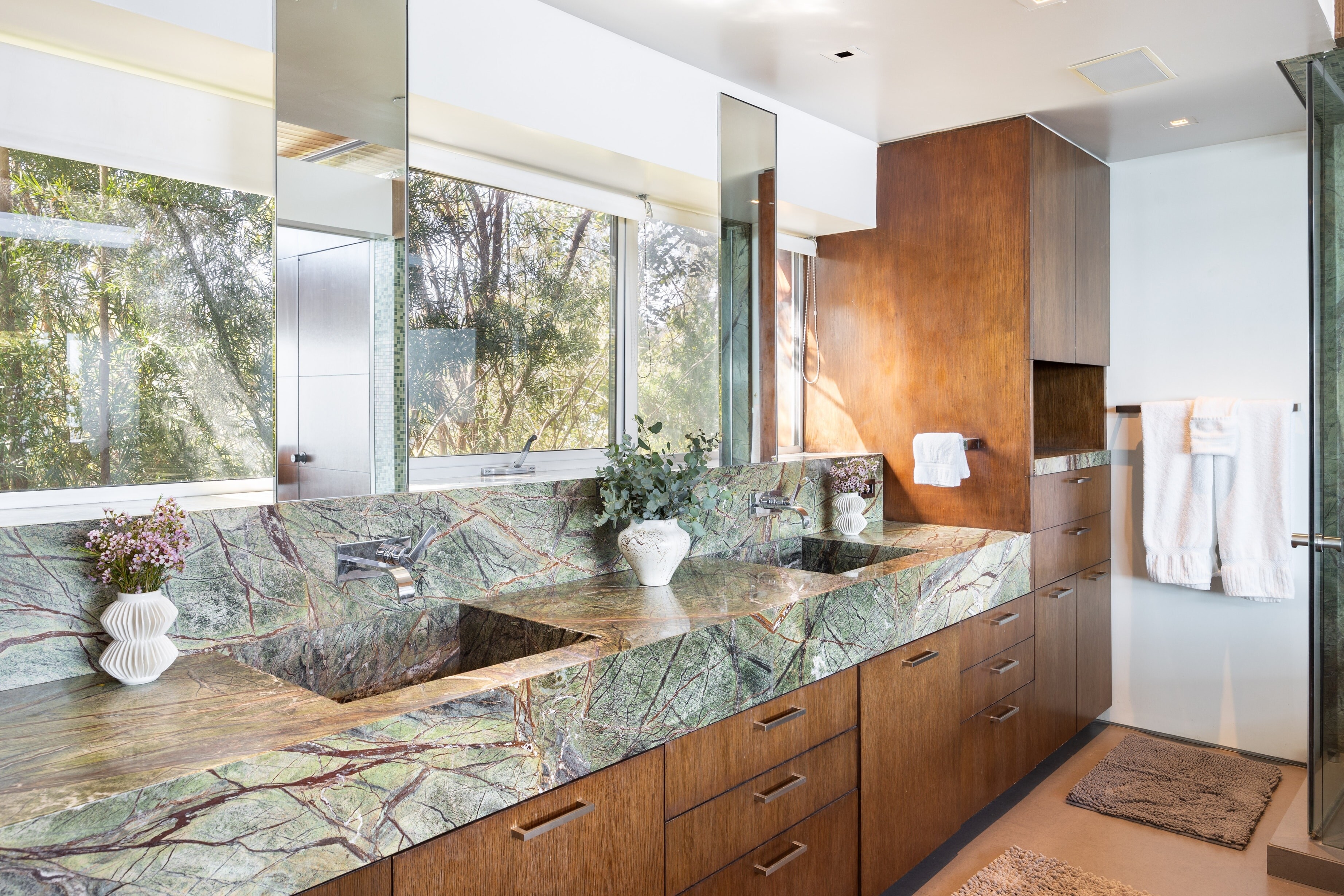 Primary bedroom's ensuite bathroom offers dual sinks.