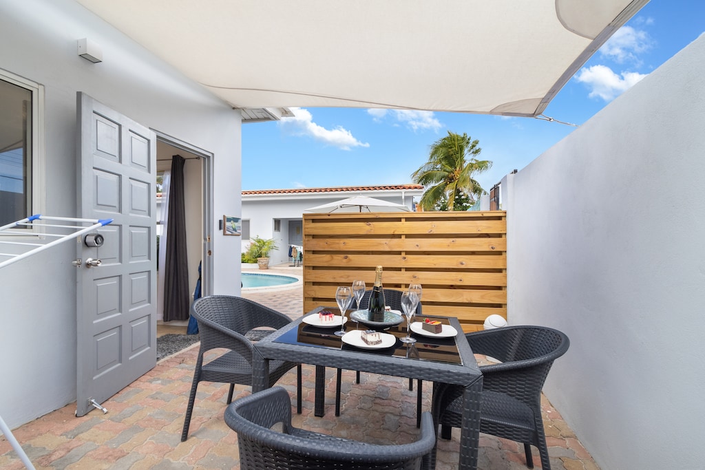 Outside Private patio of the Apartment in Noord Aruba - Dining for 4 Persons - Connect with nature and relish changes - Turn your meal into a brief getaway from regular indoors