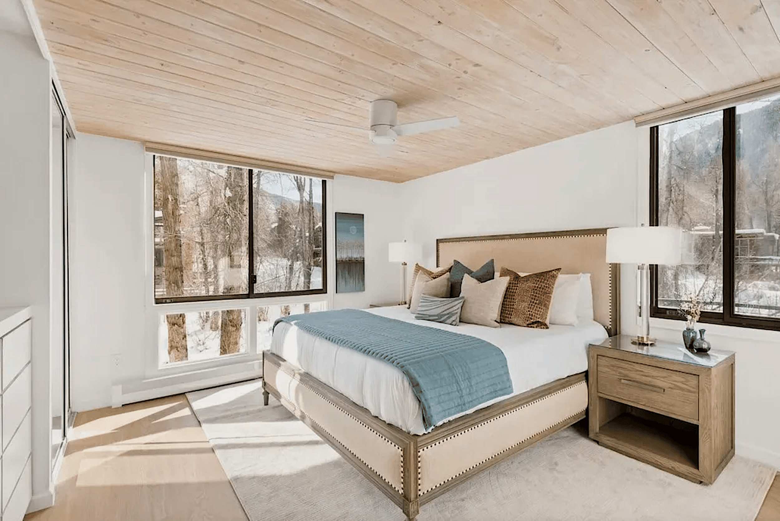 Primary bedroom with ceiling-to-floor windows w/ view of Roaring Fork river below.