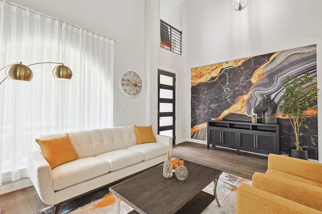 With its high ceilings and floor-to-ceiling windows, this sophisticated living room is the perfect place to sit back and catch up with some of your favorite people.