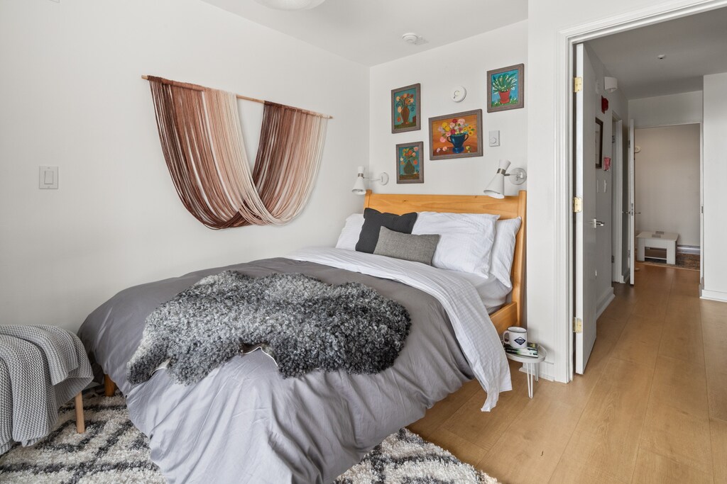 - Bedroom with queen bed, framed art and cozy blankets included   - Airbnb stay provides restful space with stylish wall accents   - Vacation rental offers bright room perfect for relaxation