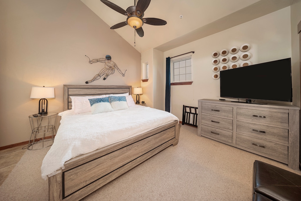 - Bedroom with king bed, TV, and rustic mountain-inspired art   - Sleep soundly in a bright cozy space with soft bedding inside   - Relax after skiing or hiking and enjoy comfort with style