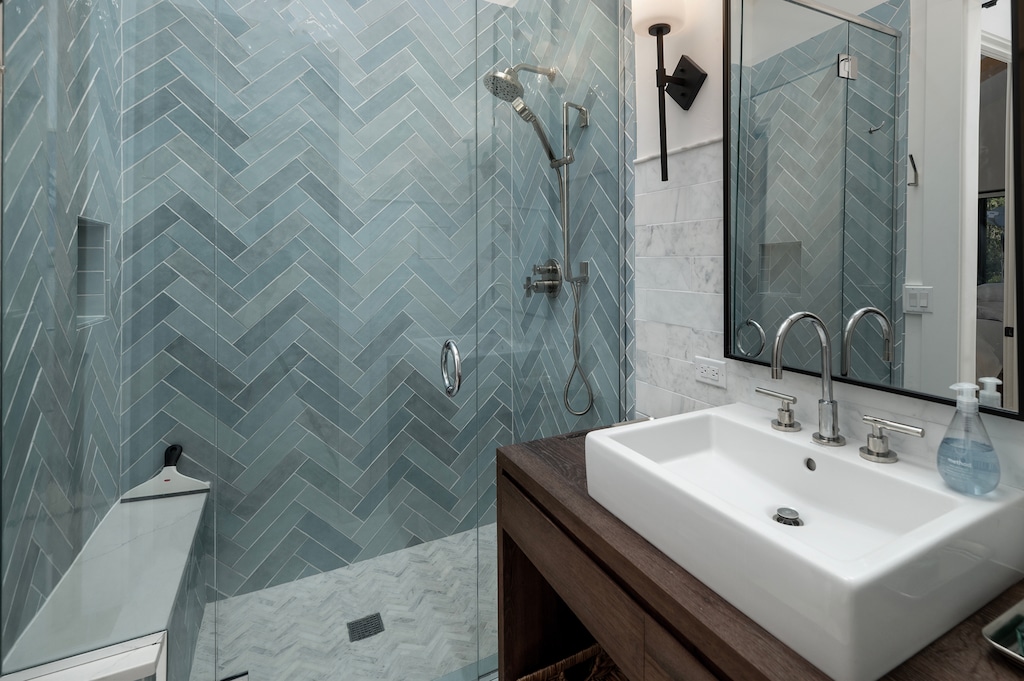 ust between Bedrooms #3 and #2, you'll find the hall bathroom, featuring a beautifully tiled, glass-enclosed shower—perfect for freshening up