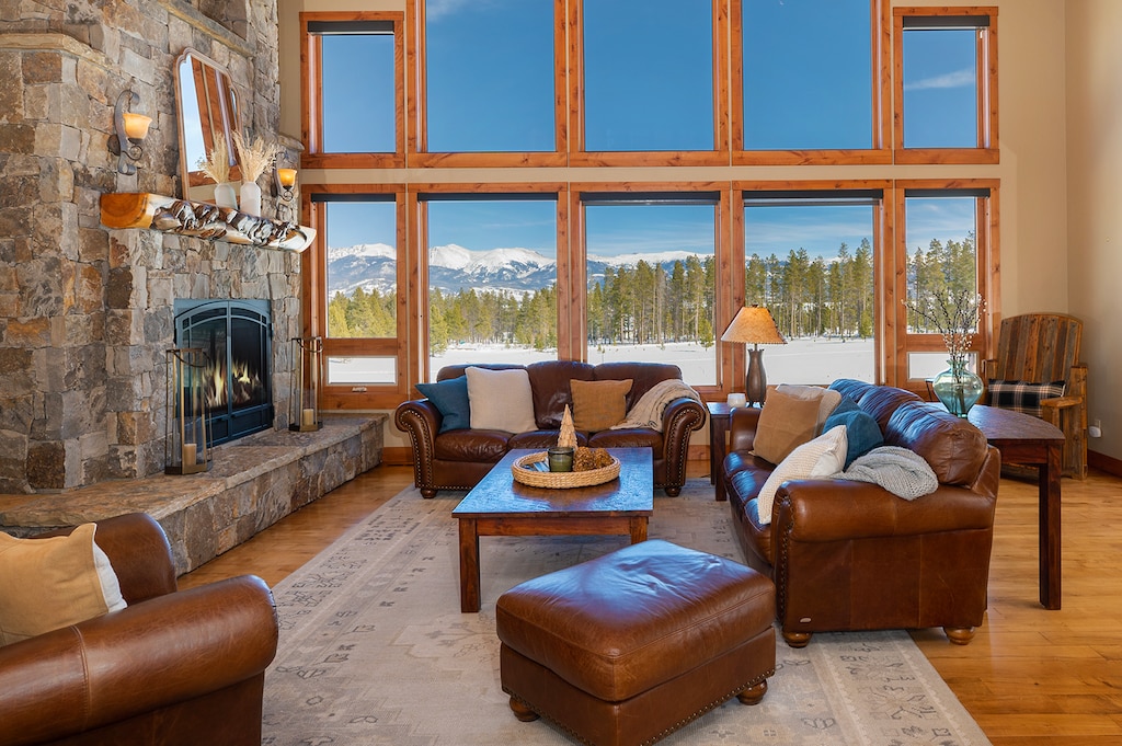 - Gather around the grand stone fireplace in this cozy mountain lounge - Floor to ceiling windows frame breathtaking views of snowy peaks - Leather seating and rustic accents invite warm, relaxed conversation