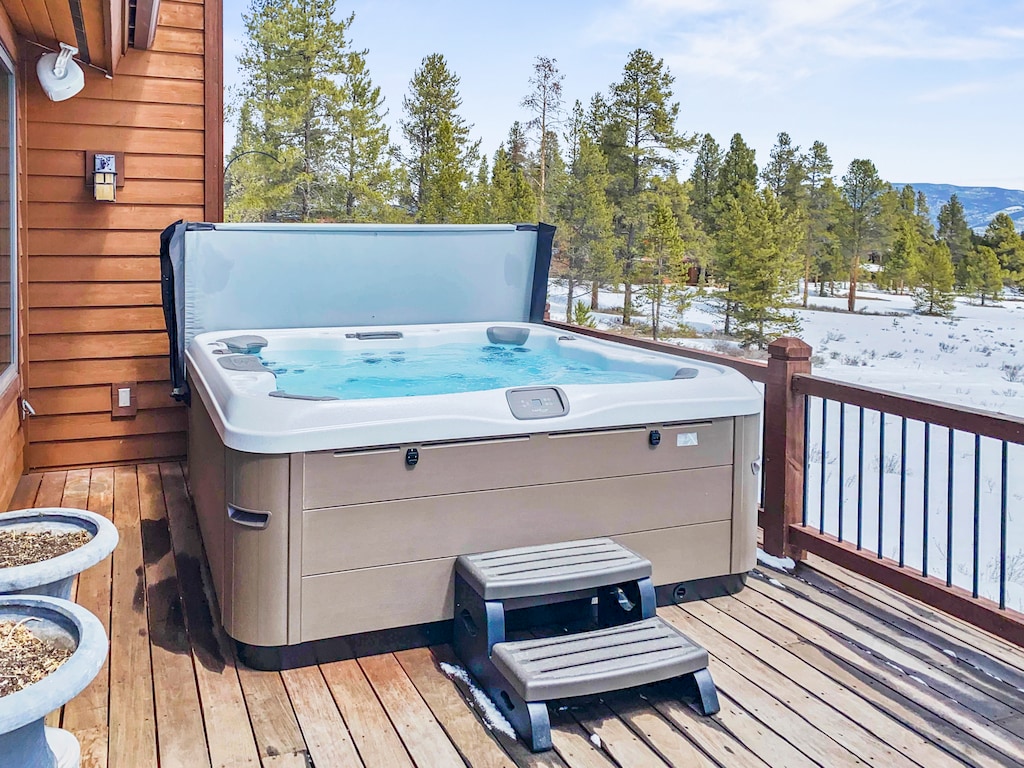 - Soak in the private outdoor hot tub while gazing at snow dusted pines - Relax on the spacious deck after skiing, hiking, or mountain exploring - Steps provide easy access to bubbling warmth in a serene alpine setting