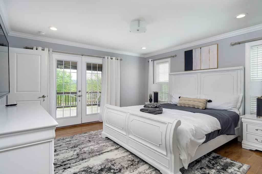 The primary bedroom has French doors that open to the expansive upper deck, complete with hanging macrame seats and rattan furniture. (Bedroom 1)