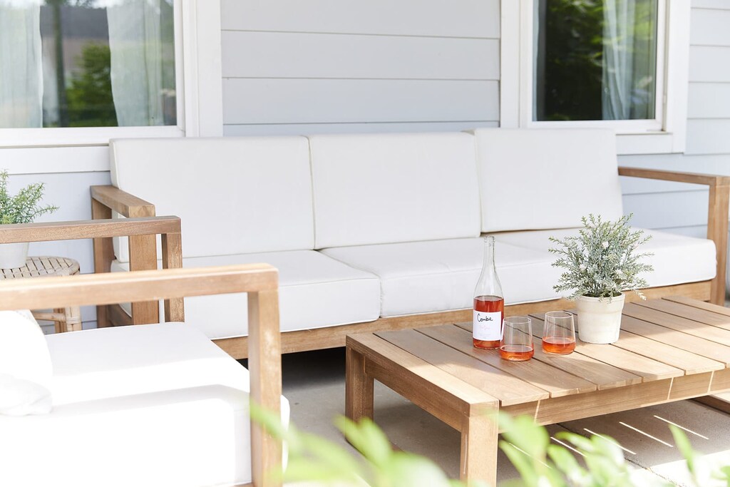 Our front porch features a cozy couch and chair, perfect for lounging in the fresh air.