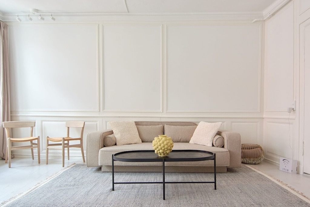 The large windows in this room provide an abundance of natural light, creating a bright and airy atmosphere that's perfect for relaxing or entertaining.