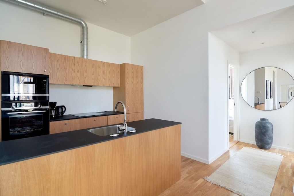 Unleash your culinary creativity in this fully equipped kitchen with ample space to cook, featuring a convenient island that adds functionality and style, making it a delightful haven for culinary adventures and shared meals.