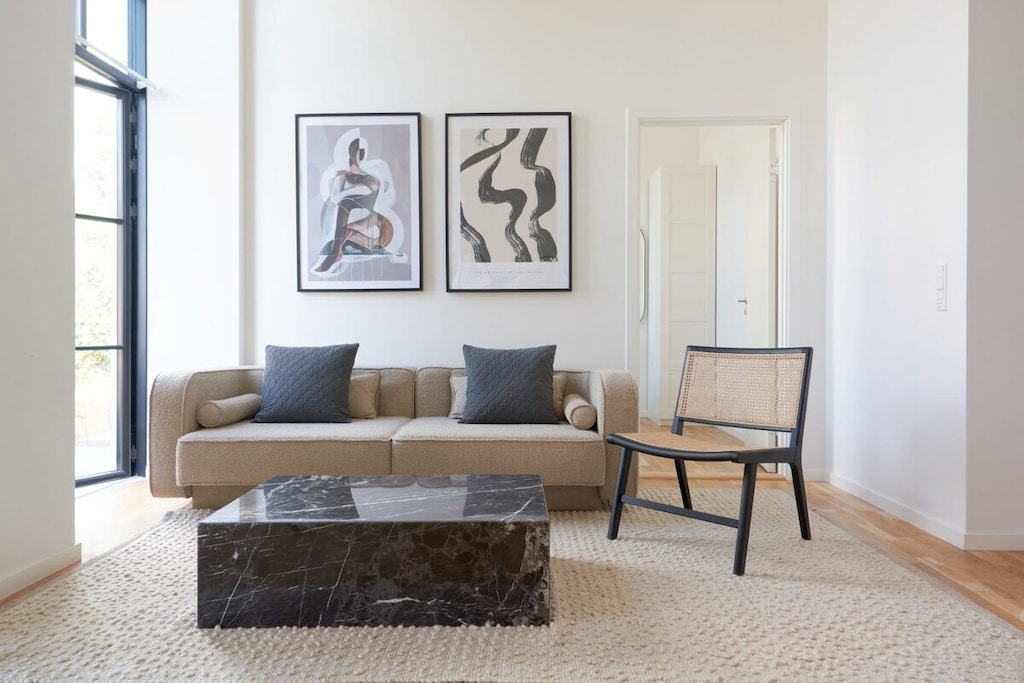 The sofa is the centerpiece of the room, featuring a sleek and modern design that seamlessly blends with the rest of the space.