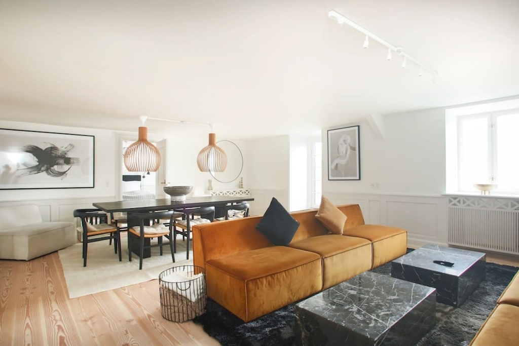 This living room features large windows and a fantastic open layout that will leave you breathless. The room is anchored by a stunning large wall art pieces that adds a pop of color and character to the space.