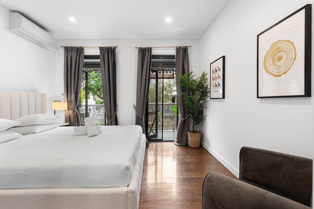 The beautiful master bedroom, with king bed, private balcony, walk-in wardrobe and its own a/c