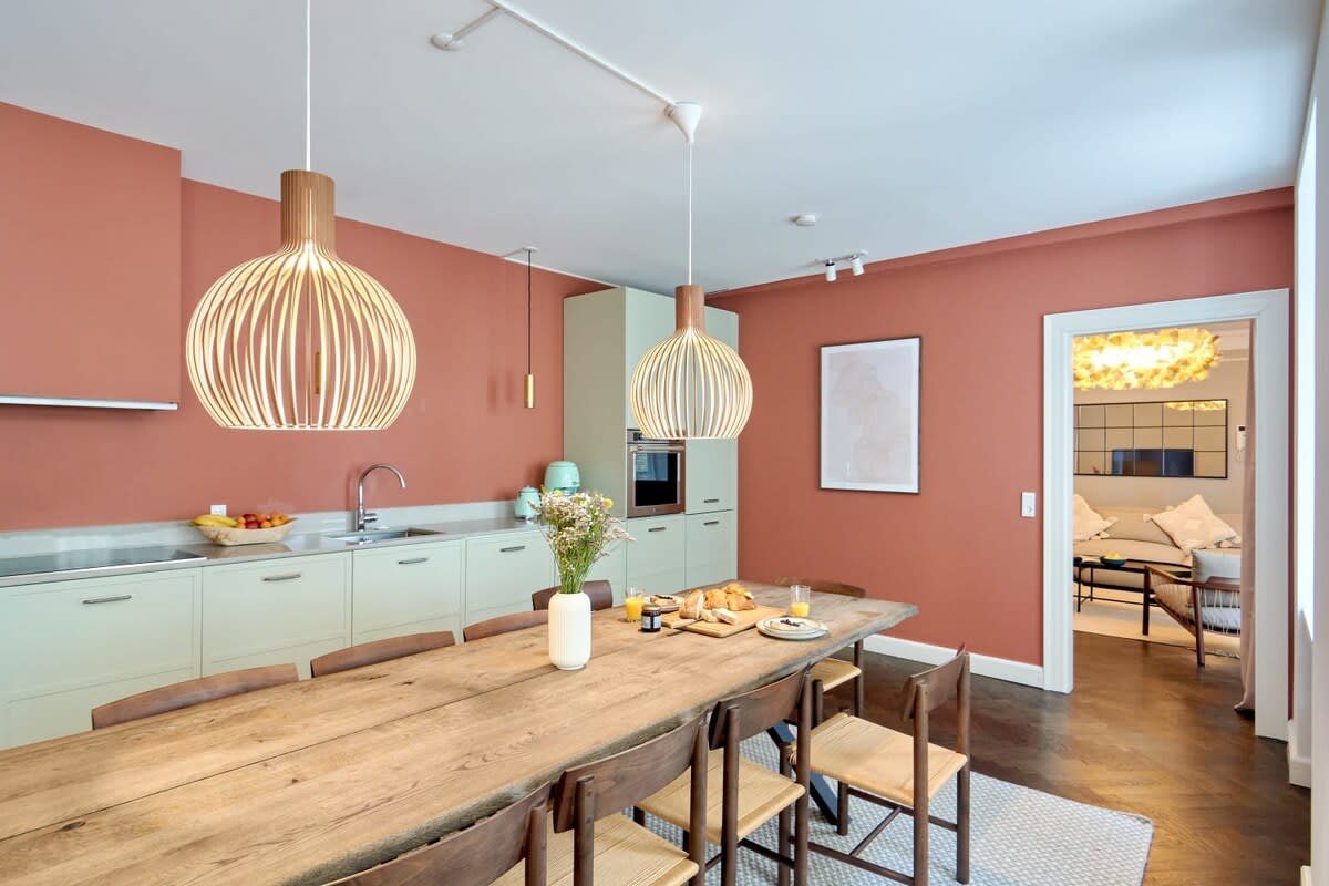 Large kitchen with a ten-seating dining area.  The kitchen's dark accent walls create a bold and fun space and add a warm and inviting ambiance.  Enjoy this space for cooking, entertaining, and gathering with family and friends.