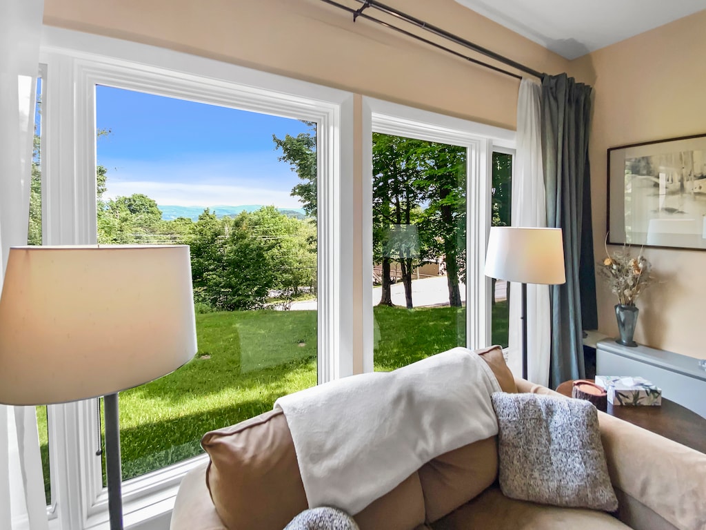 - Scenic mountain views through large picture windows   - Comfortable seating by the window for quiet moments   - Natural light brightens the inviting living area