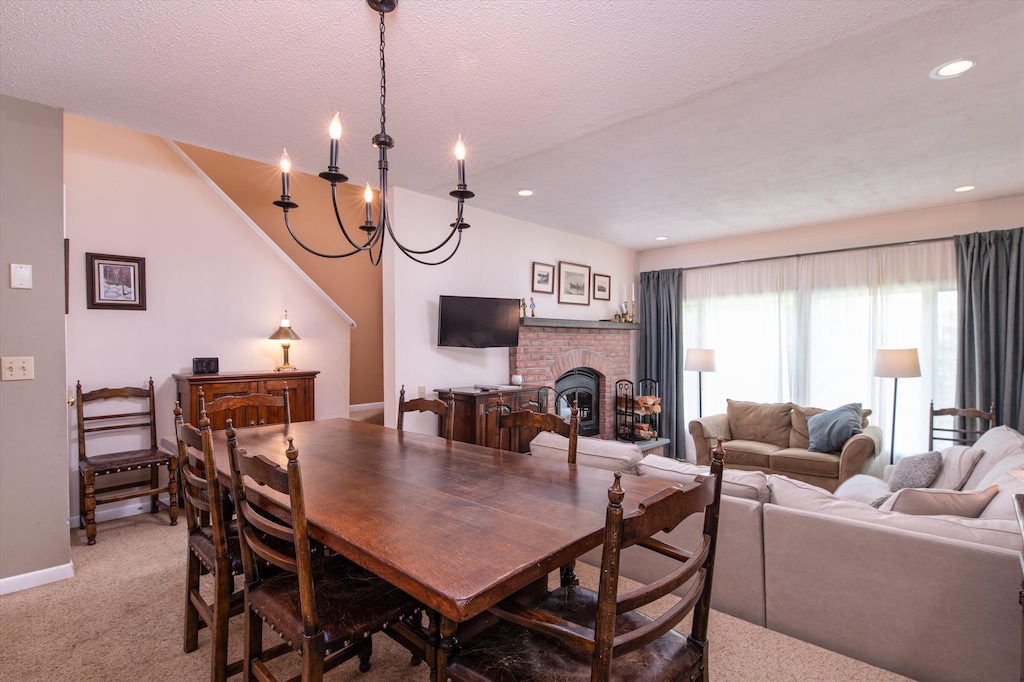 - Dining area with large wooden table and chandelier   - Gather family and friends for shared meals together   - Open layout flows into living room with fireplace