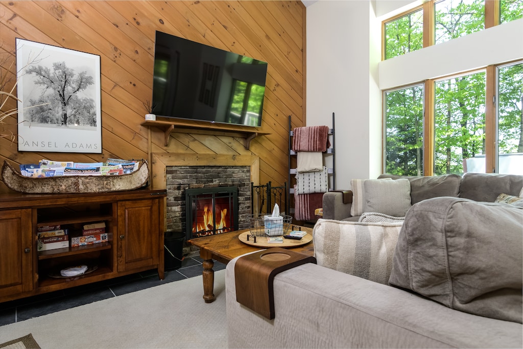 - Cozy living room with fireplace and flat screen TV for perfect family nights - Wood accents and warm lighting enhance your mountain cabin feel - Gather around for movies games or fireside chats after adventures