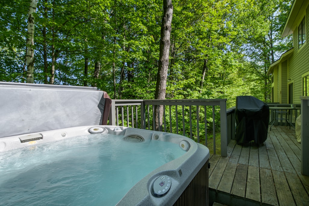 - Private hot tub on deck surrounded by trees creates a serene retreat after skiing or hiking - Relax with warm bubbles and forest views in your mountain getaway - Perfect outdoor spa experience year round