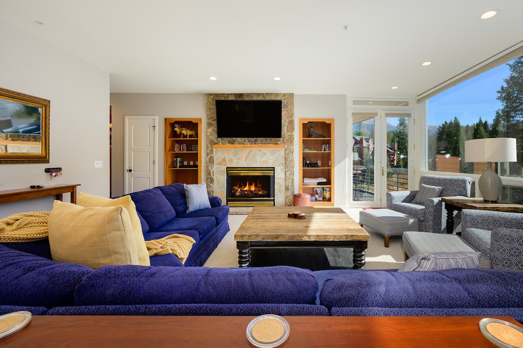 Large open living area with wooded river view