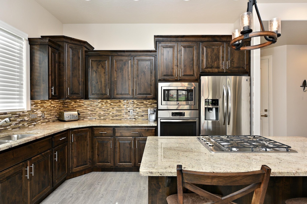 The Kitchen is complete with everything you will need for meal preparations including pots, pans, baking dishes, plates, cups, silverware, cutlery, and an assortment of cooking utensils.