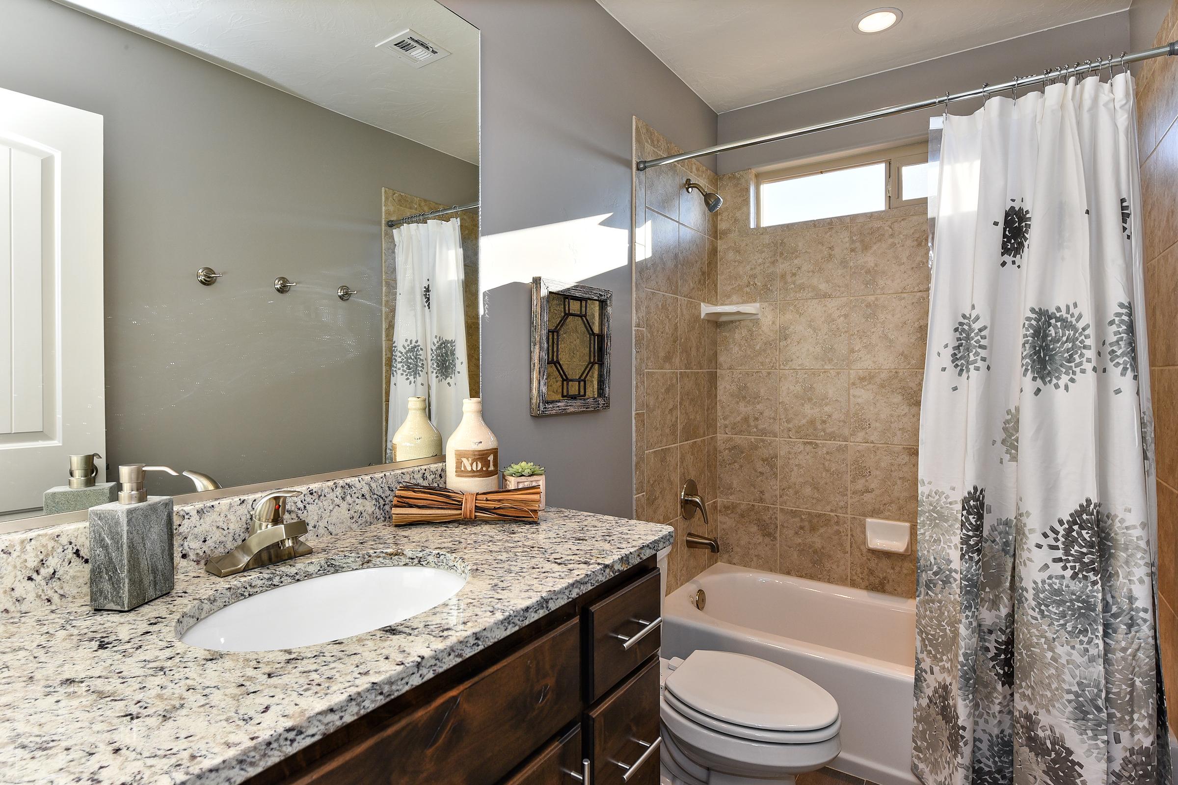 Bathroom 3 is located upstairs and is positioned in between Bedrooms 3 and 4.  It includes a combination shower/tub, toilet, sink, vanity, and plenty of drawer space.