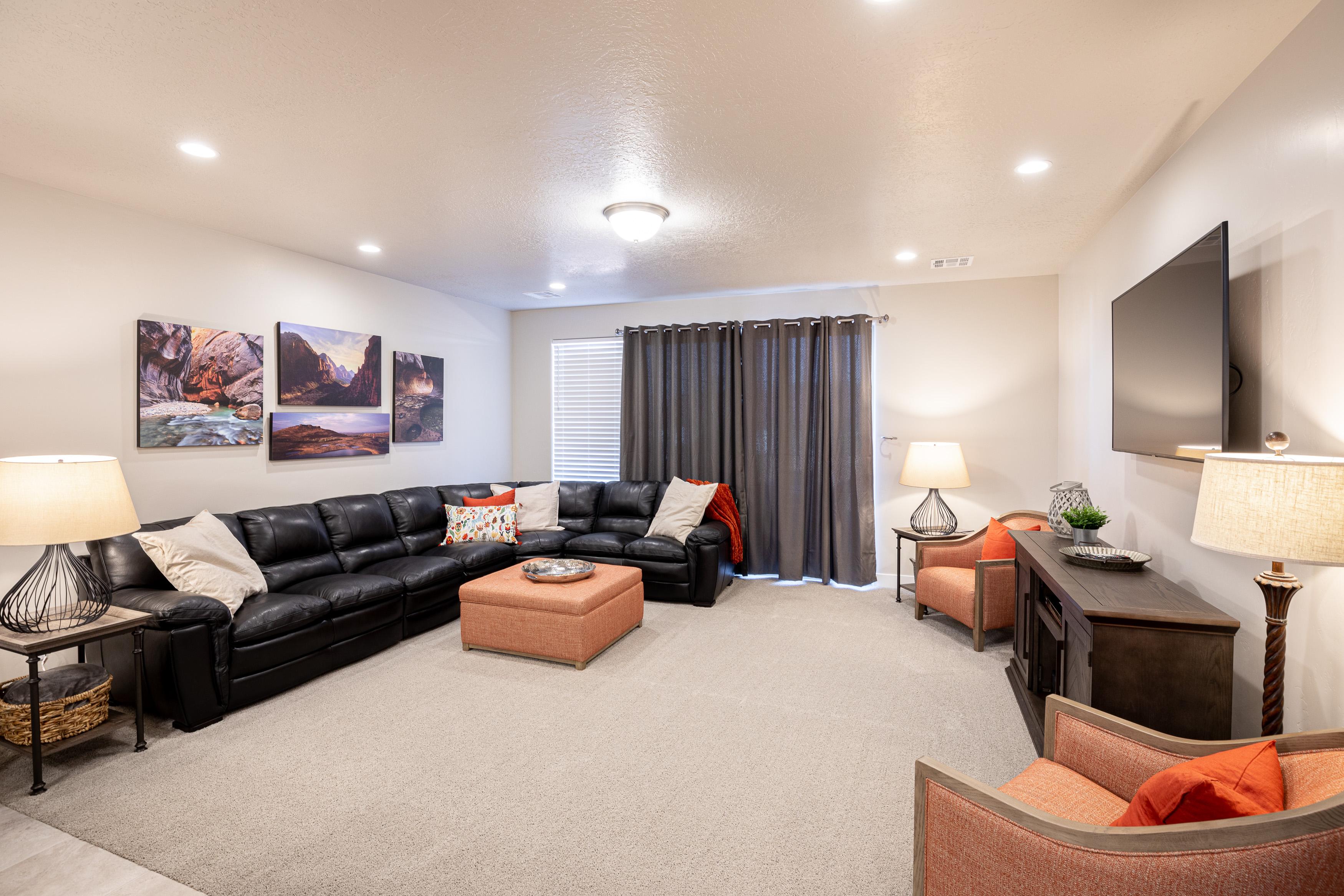 The living room is conveniently adjacent to the kitchen. There is also access to the back patio which has a BBQ grille suitable for all your favorite BBQ dishes.