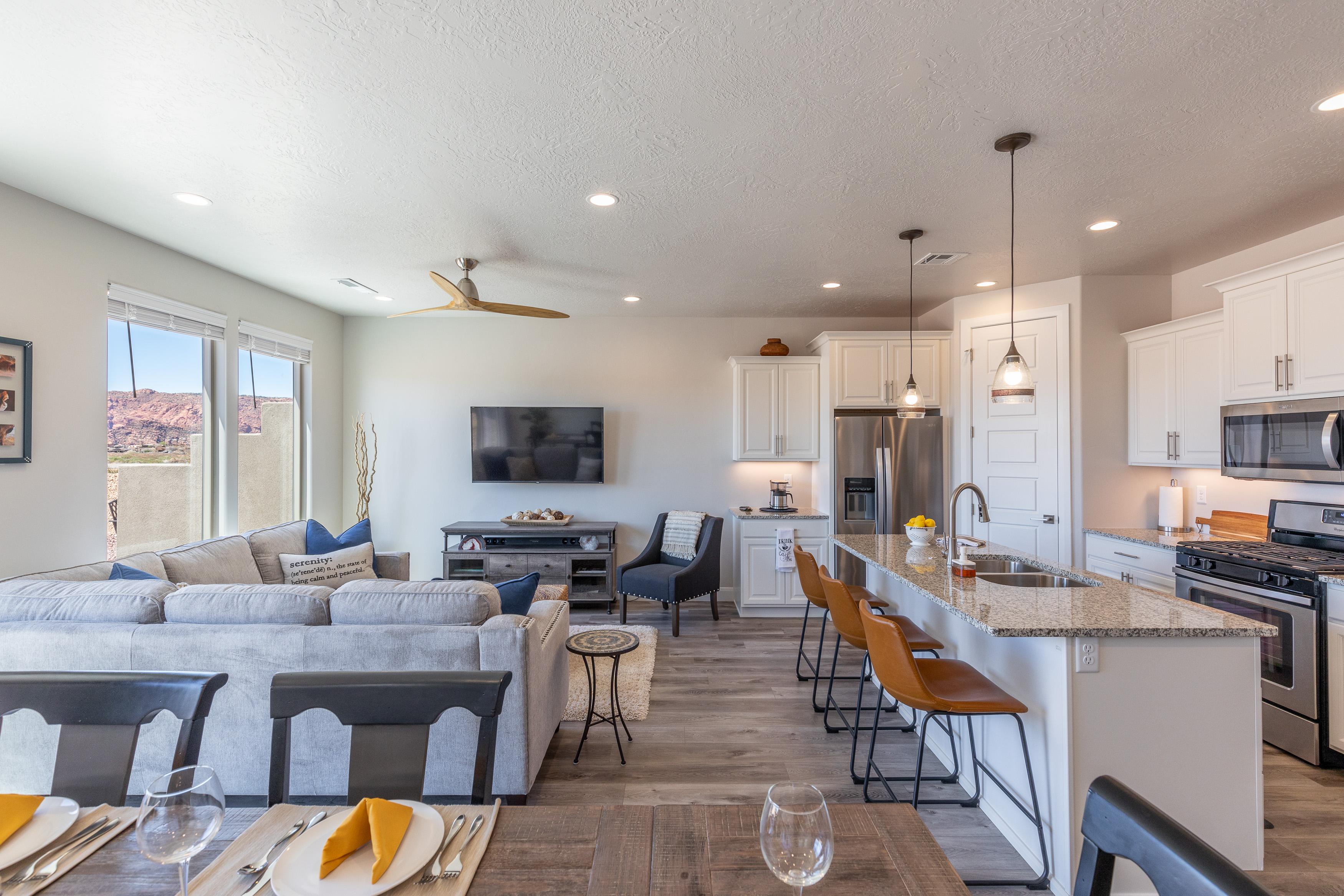 The living room is designed as an open floor plan and is a great gathering place for meals, games, or watching TV during your stay. Notice the view from this room!