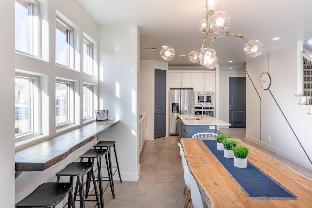 Share memories and stories while enjoying a family style meal around the Dining Table with extra seating at the bar top and kitchen island.