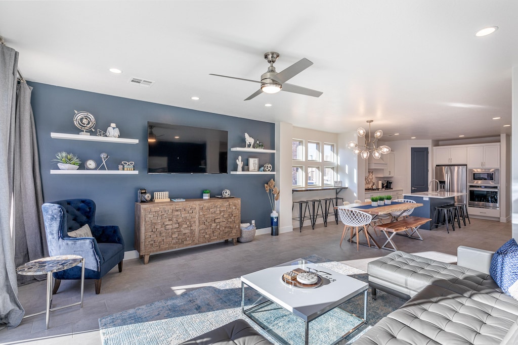 The living room is designed as an open floor plan and is a great gathering place for meals, games, or watching TV during your stay.