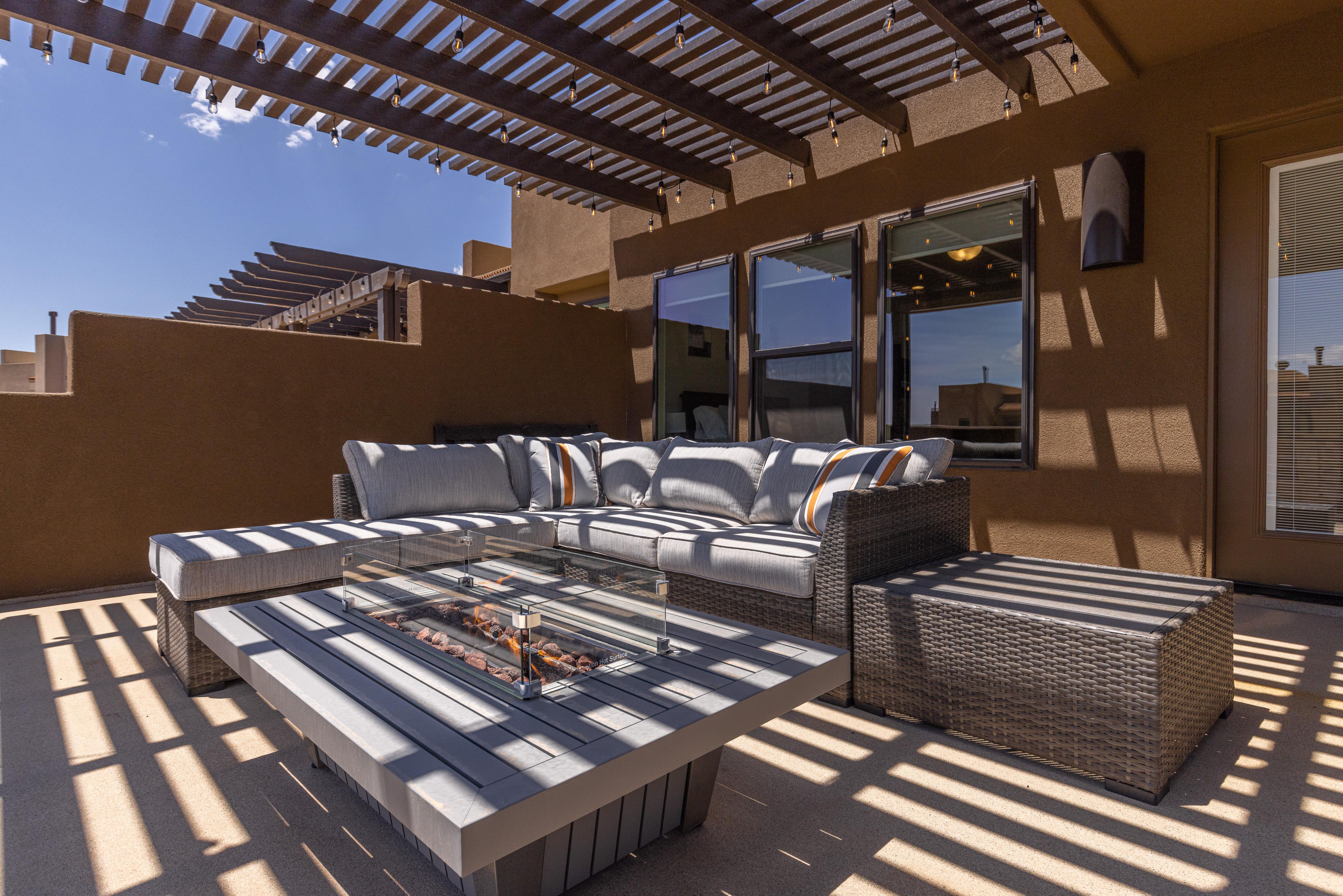 Enjoy the weather under the pergola while sitting in our comfortable patio furniture.