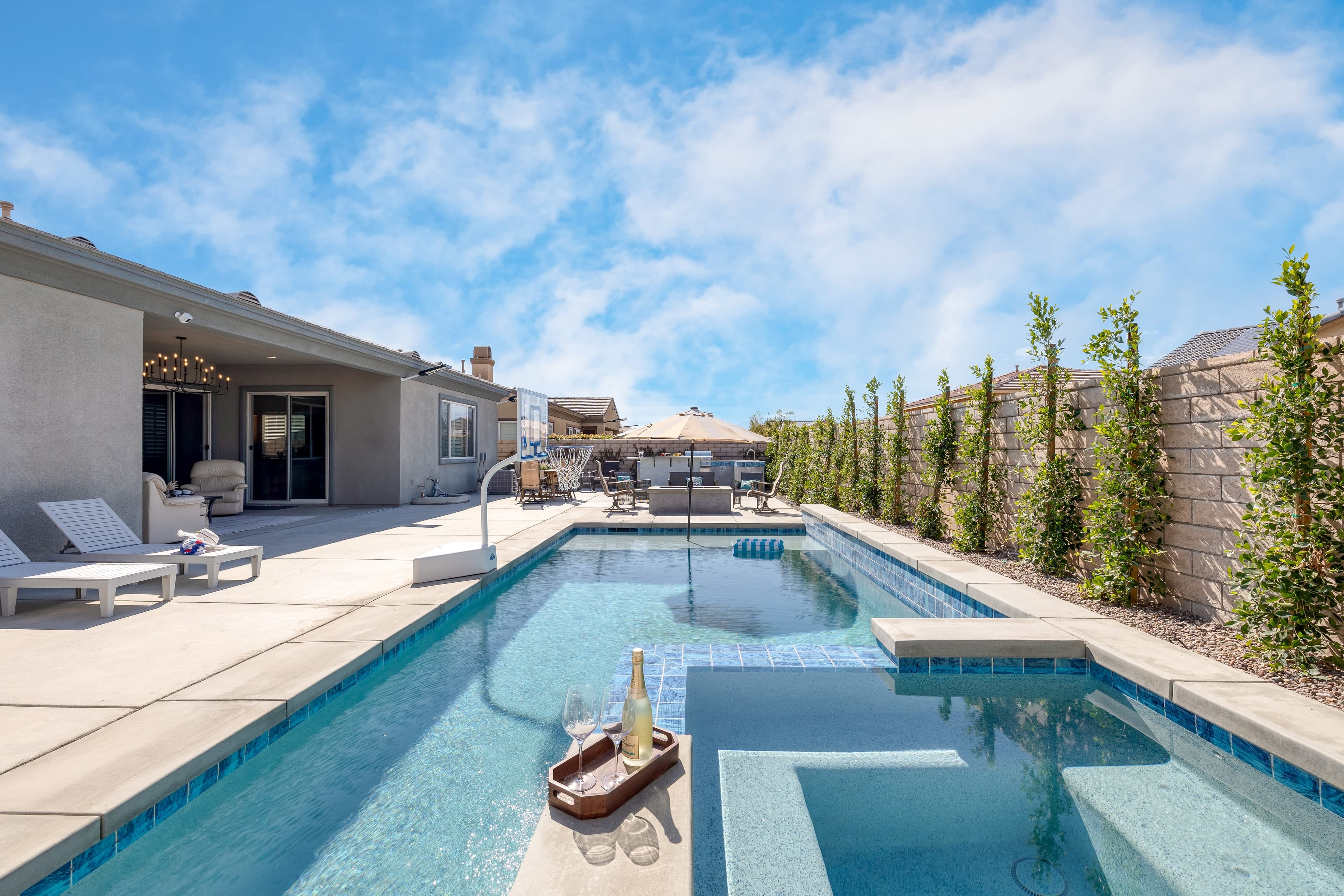 Beautiful backyard with a private pool, basketball hoop, patio, and firepit.