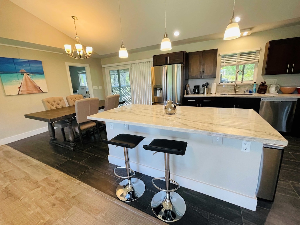 Delight in a sleek and functional kitchen featuring quartz countertops, stainless steel appliances, and modern cabinetry—perfect for preparing everything from quick breakfasts to gourmet dinners.