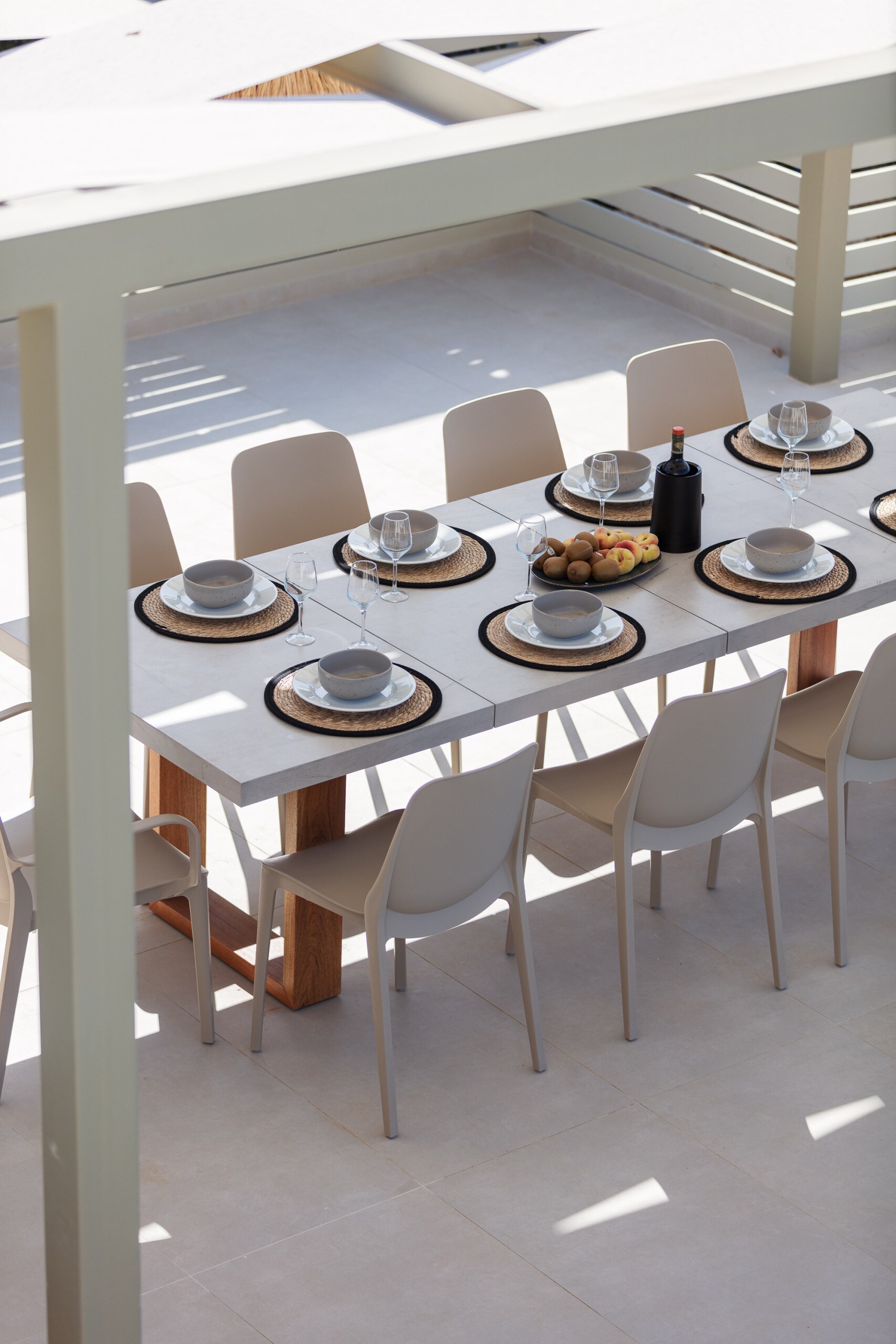 A shaded outdoor dining area next to the pool.