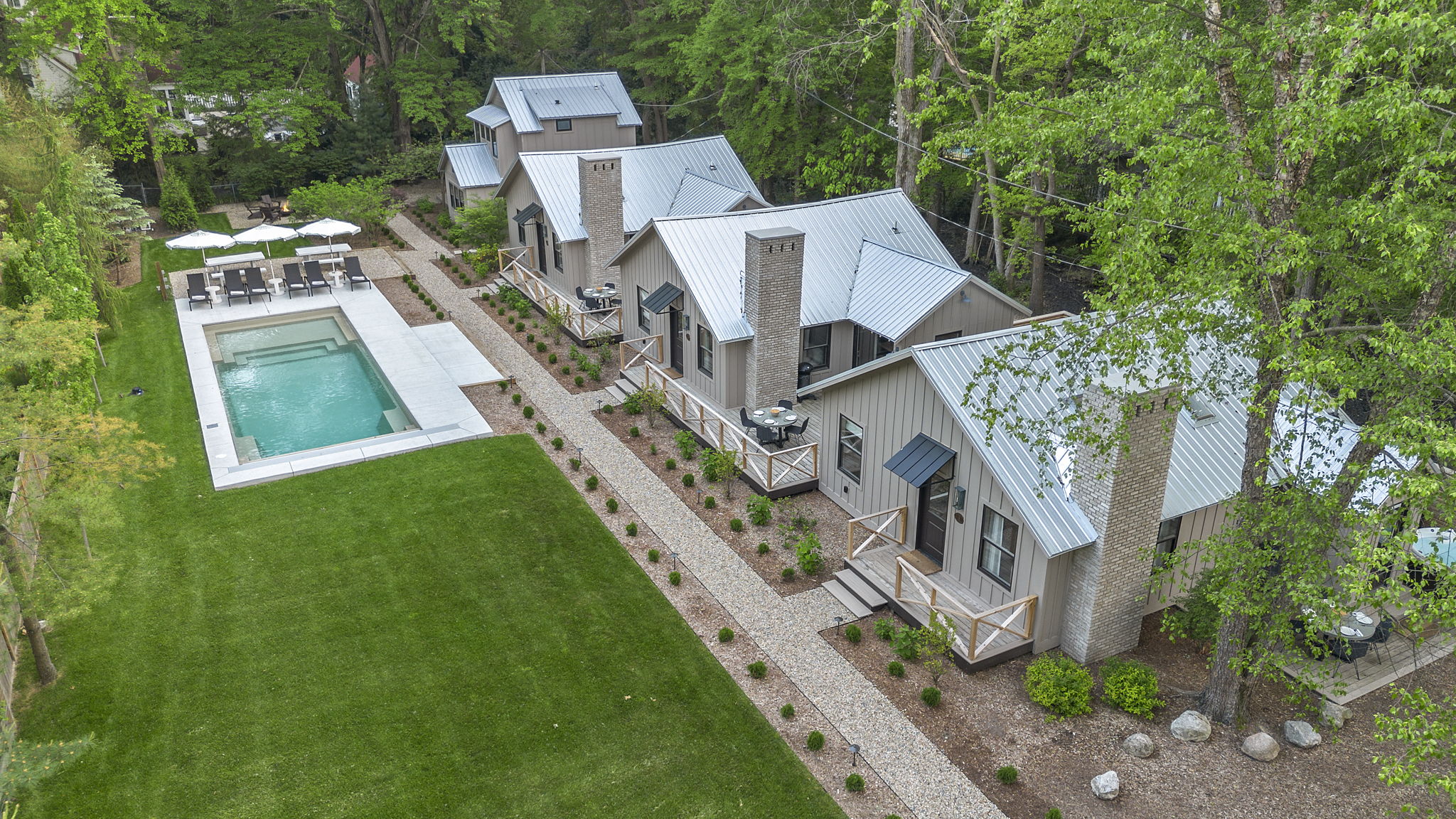 Embrace the tranquility of this beautiful residence featuring a refreshing pool and a vibrant lawn.