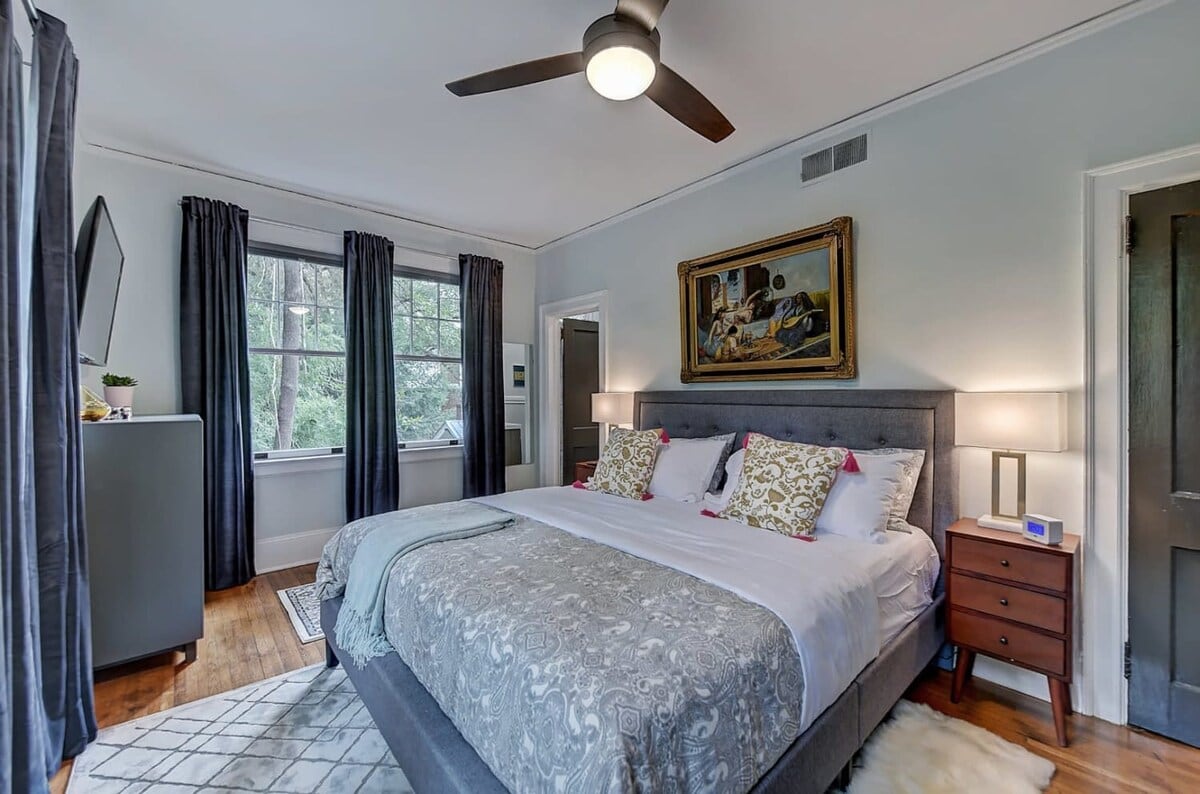 Cozy bedroom with set of pillows and lots of lighting