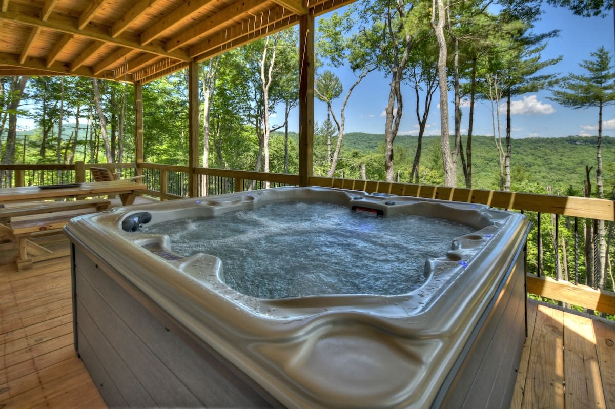 Soak your cares away in the hot tub overlooking beautiful mountain views!