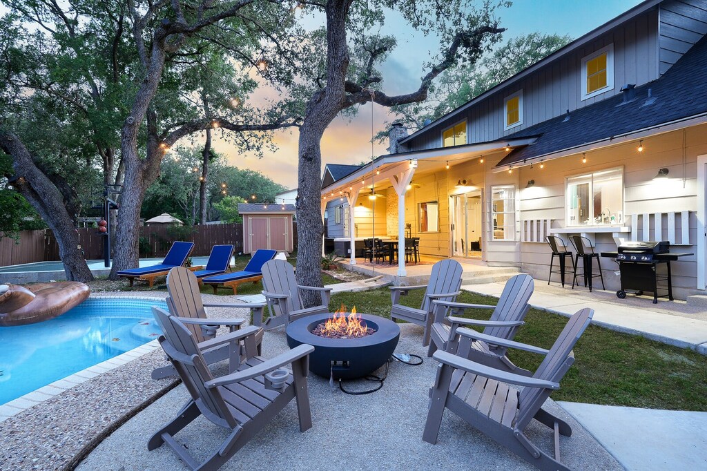 Enjoying the backyard with fireplace, grill, and pool in sight!