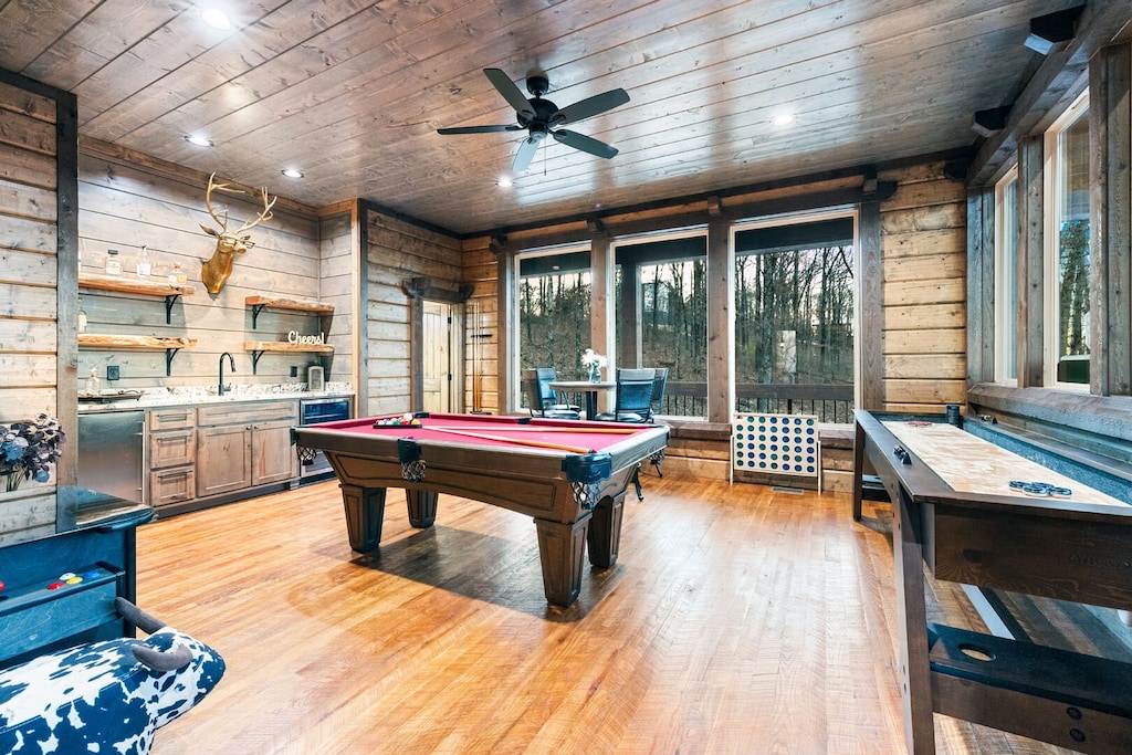 Game room downstairs includes pool table, shuffleboard, arcade game, and large connect 4