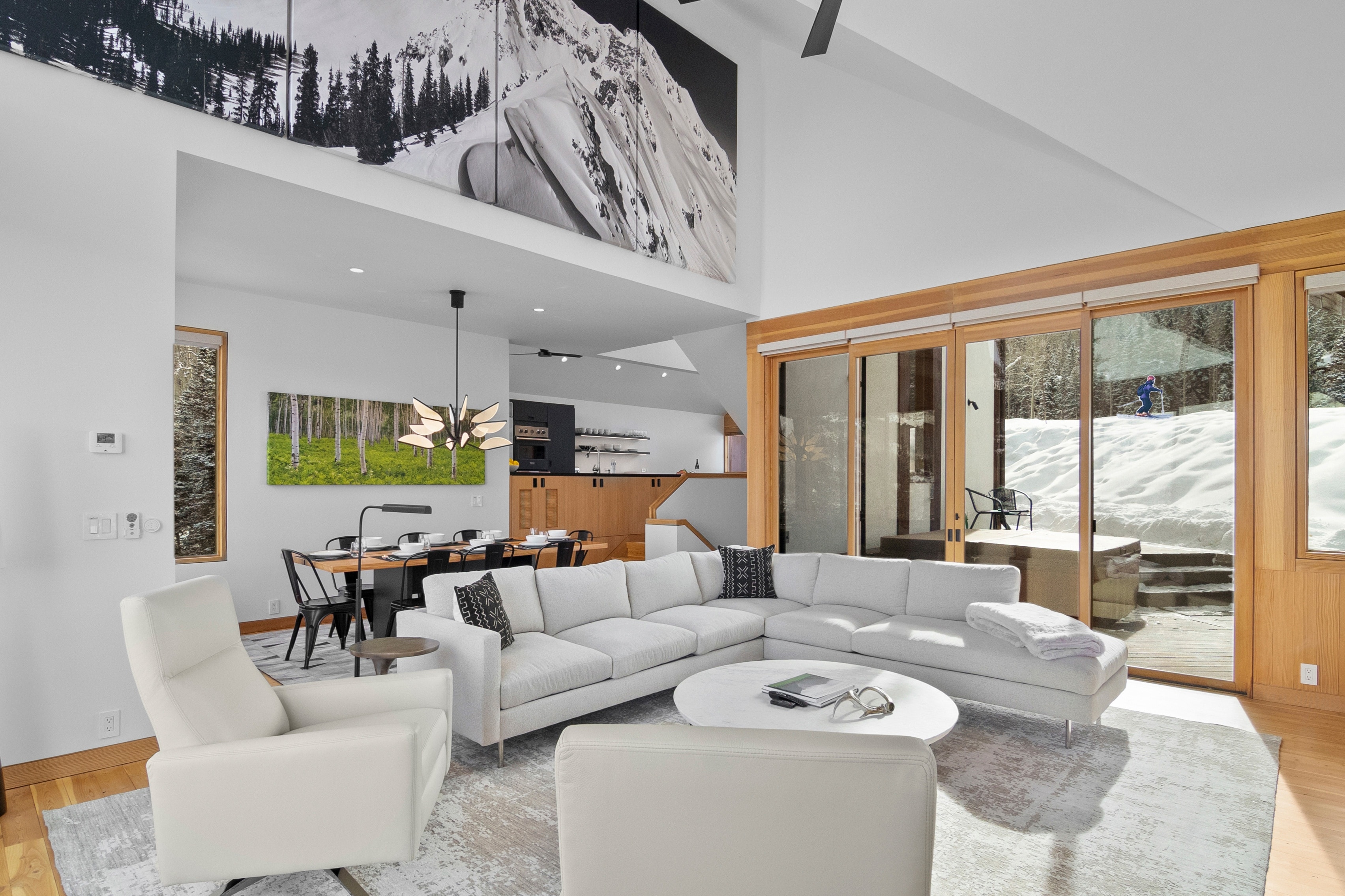 The top floor features a big open living room area with views of Sundancer ski run and skiers flying by getting down the mountain and enjoying the slopes.