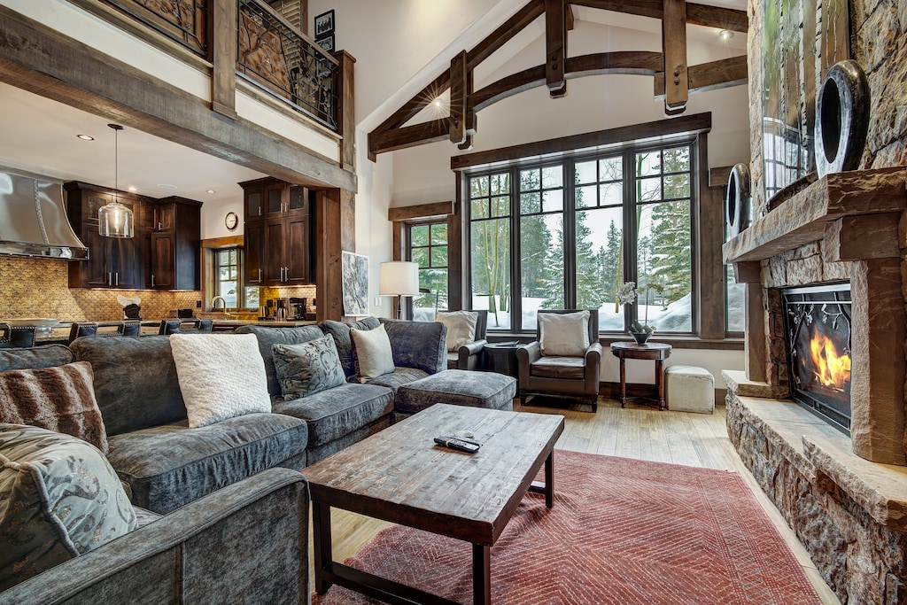 This is a photo of the living area with a view of the kitchen in the background