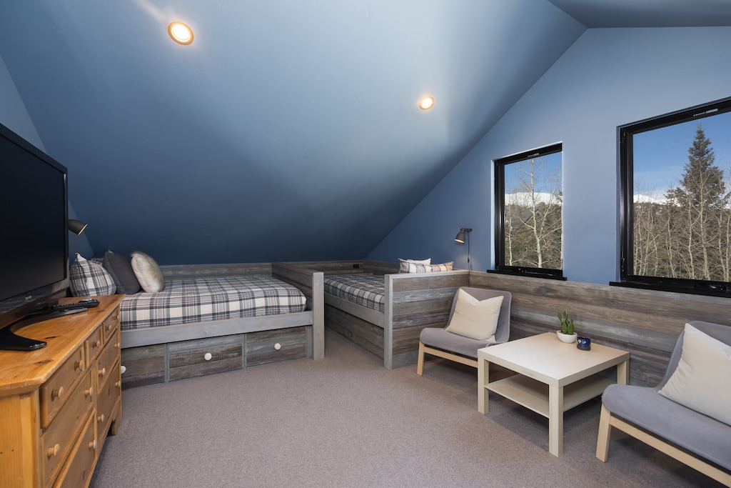 Cottage  Top level – two Twin beds, one Full bed, SmartTV on a dresser, plus a closet and a full bathroom with a shower and tub combination